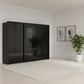 Rauch Heaven 300cm 3 Door Slider Wardrobe with Glass Doors in Black styled in a modern bedroom