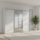 Rauch Heaven 300cm 3 Door Slider Wardrobe with 2 Glass Doors and 1 Mirror Door in Silk Grey styled in a modern bedroom