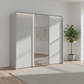 Rauch Heaven 240cm 3 Door Slider Wardrobe with 2 Décor Doors, 1 Mirror Door and Lights in Silk Grey styled in a modern bedroom