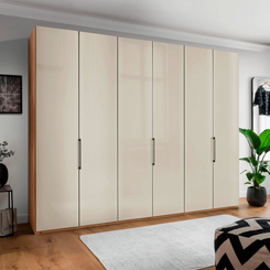 Templin 1000 6 Door Hinged Wardrobe in Bianco Oak Carcase & Champagne Glass Front - Styled in a Bedroom