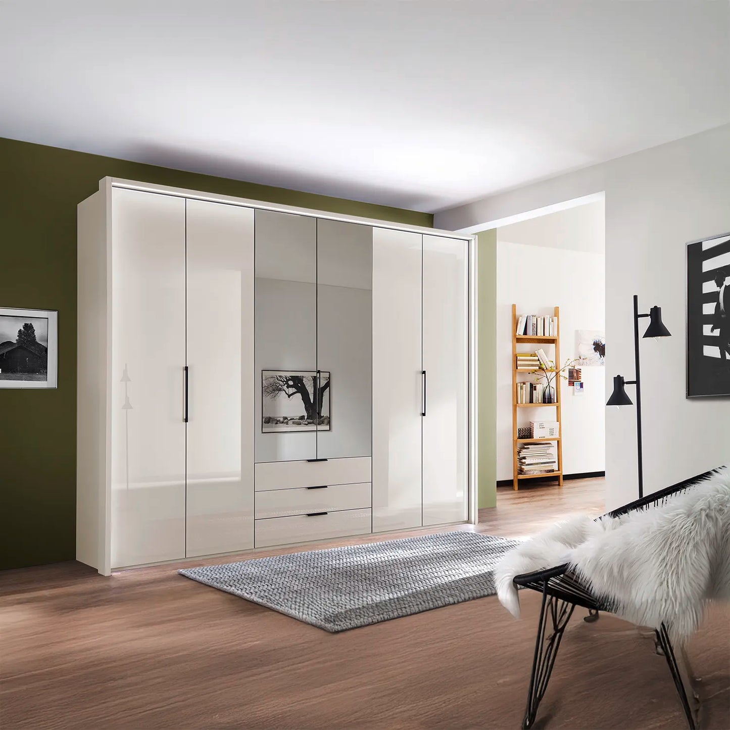 Templin 2000 Champagne Glass 6 Door 3 Drawers 225cm Bifold Wardrobe With Mirror - Styled in a Living Room