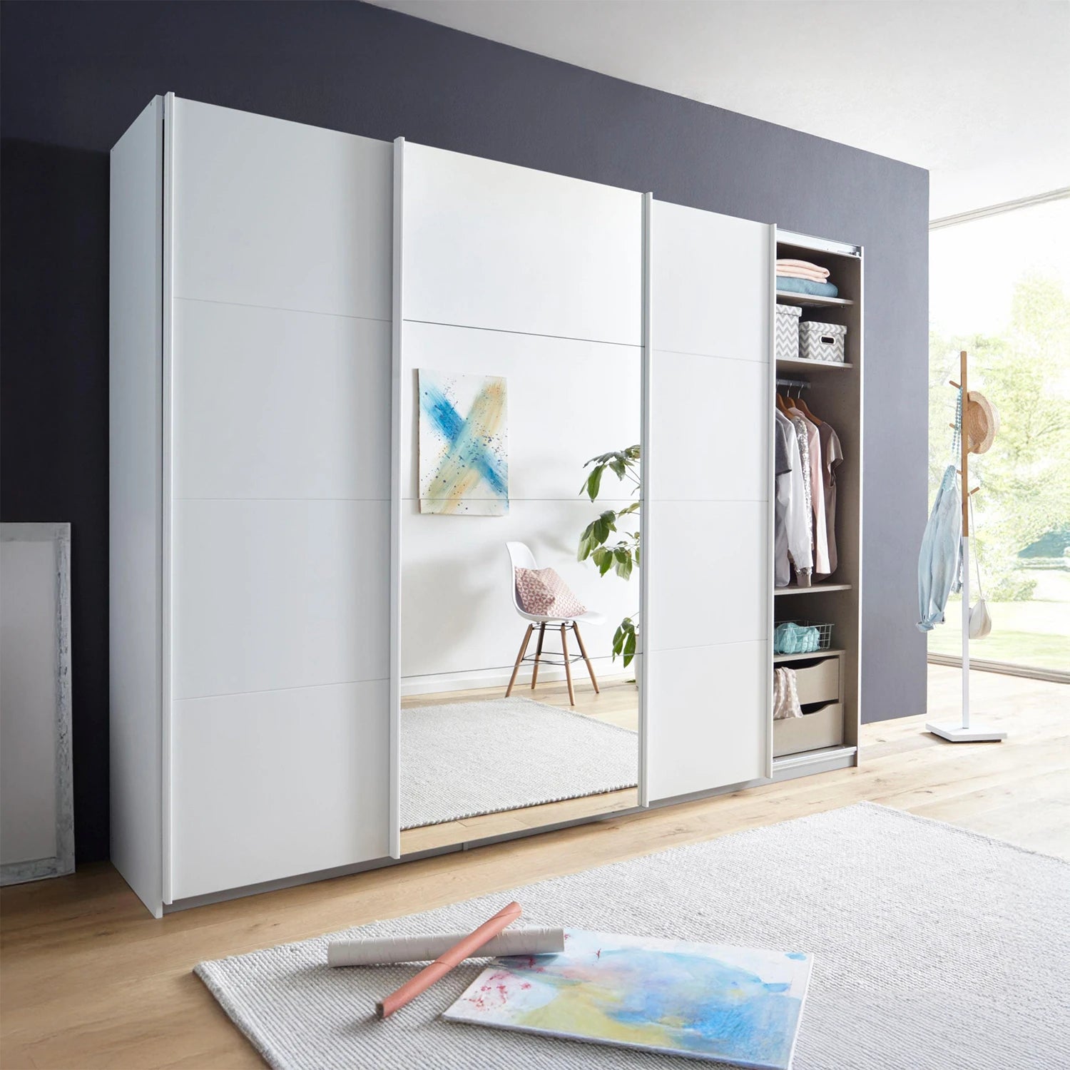 Modern wardrobe with sliding doors in a room with a rug and decor items.