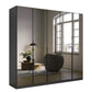 Modern wardrobe with grey mirror doors reflecting a room with a window and decor.