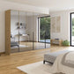 Modern bedroom with a large mirrored wardrobe and a bed.
