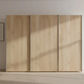 Bianco Oak Wooden wardrobe with sliding doors in a minimalistic room.