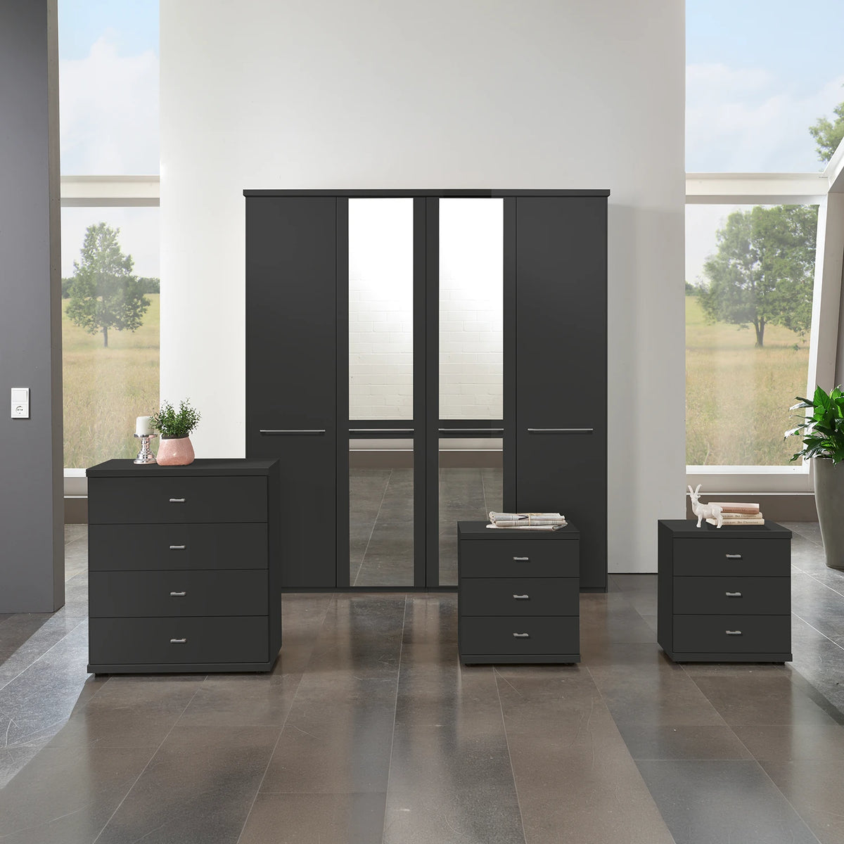 A modern Wiemann Cairns 4 Piece bedroom furniture set consisting of a four-door wardrobe with Mirror, a four-drawer chest, a pair of three-drawer bedside table in Graphite colour
