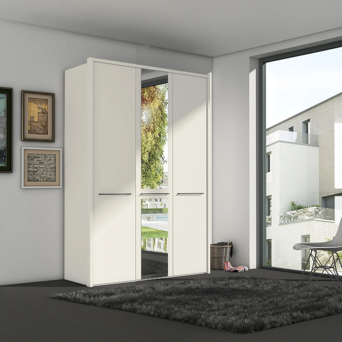 A modern Wiemann Kairns known as cairns white three-door wardrobe with central door featuring mirrored glass panels, shown in a contemporary room setting with a dark gray rug and a large window.