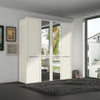 A modern white Wiemann Cairns wardrobe with two mirrored doors and two solid doors, set in a contemporary room with a dark gray rug and framed wall art.