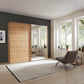 The Corfu Bianco Oak Sliding Wardrobe features mirrored 3-panel doors, smooth-glide rails, adjustable shelves and space-saving style. Choose 200–300cm sizes and mirror side.

