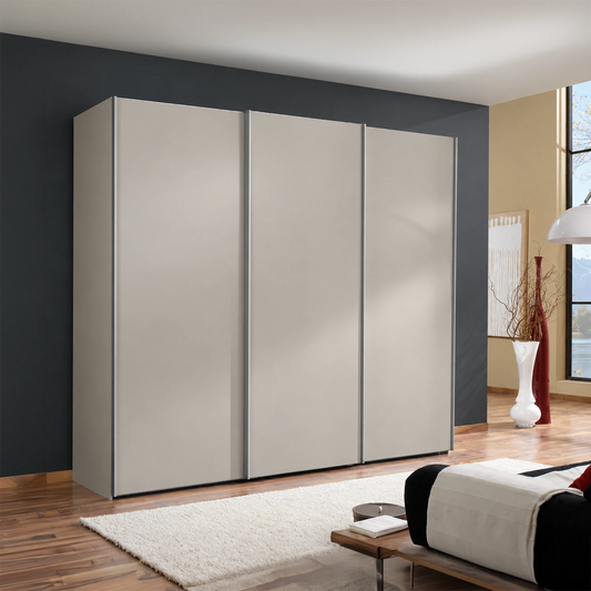 A modern Low height  three-door Wiemann Darwin wardrobe with matte Pebble Grey doors, Aluminium Door handle Bars