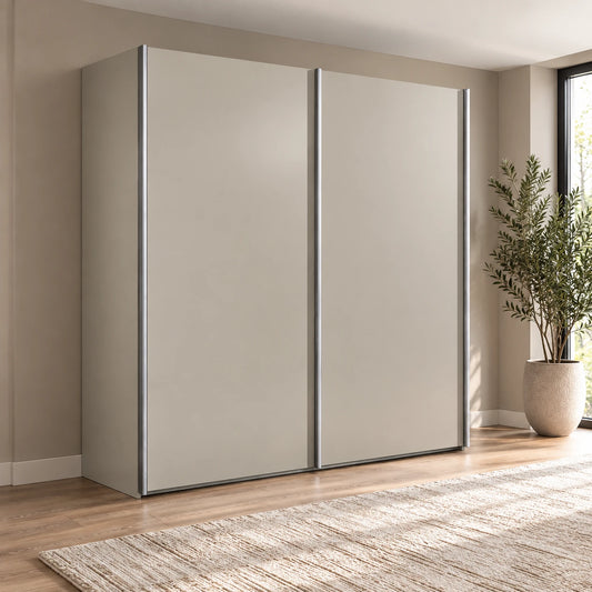 A modern two-door Wiemann Darwin sliding wardrobe with Pebble Grey doors and slim silver metal frames, set in a styled room with a wood floor, neutral wall, and a potted plant.