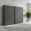 Modern black wardrobe with sliding doors in a minimalistic room.