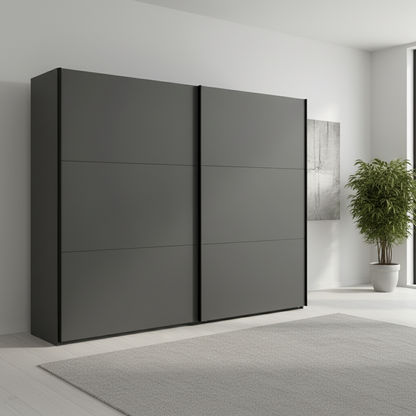 Modern black wardrobe with sliding doors in a minimalistic room.
