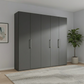 Wiemann Halver Graphite 5 Door Hinged wardrobe in a room with a plant and framed picture on the wall.