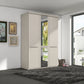 A modern 3-door Wiemann Cairns wardrobe with a mirrored door and two solid doors in a light beige finish, set in a contemporary room with a dark gray shag rug and framed wall art.
