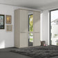 A modern 3-door Wiemann Cairns wardrobe with a mirrored door and two solid doors in a Pebble Grey finish, set in a contemporary room with a dark gray shag rug and framed wall art.