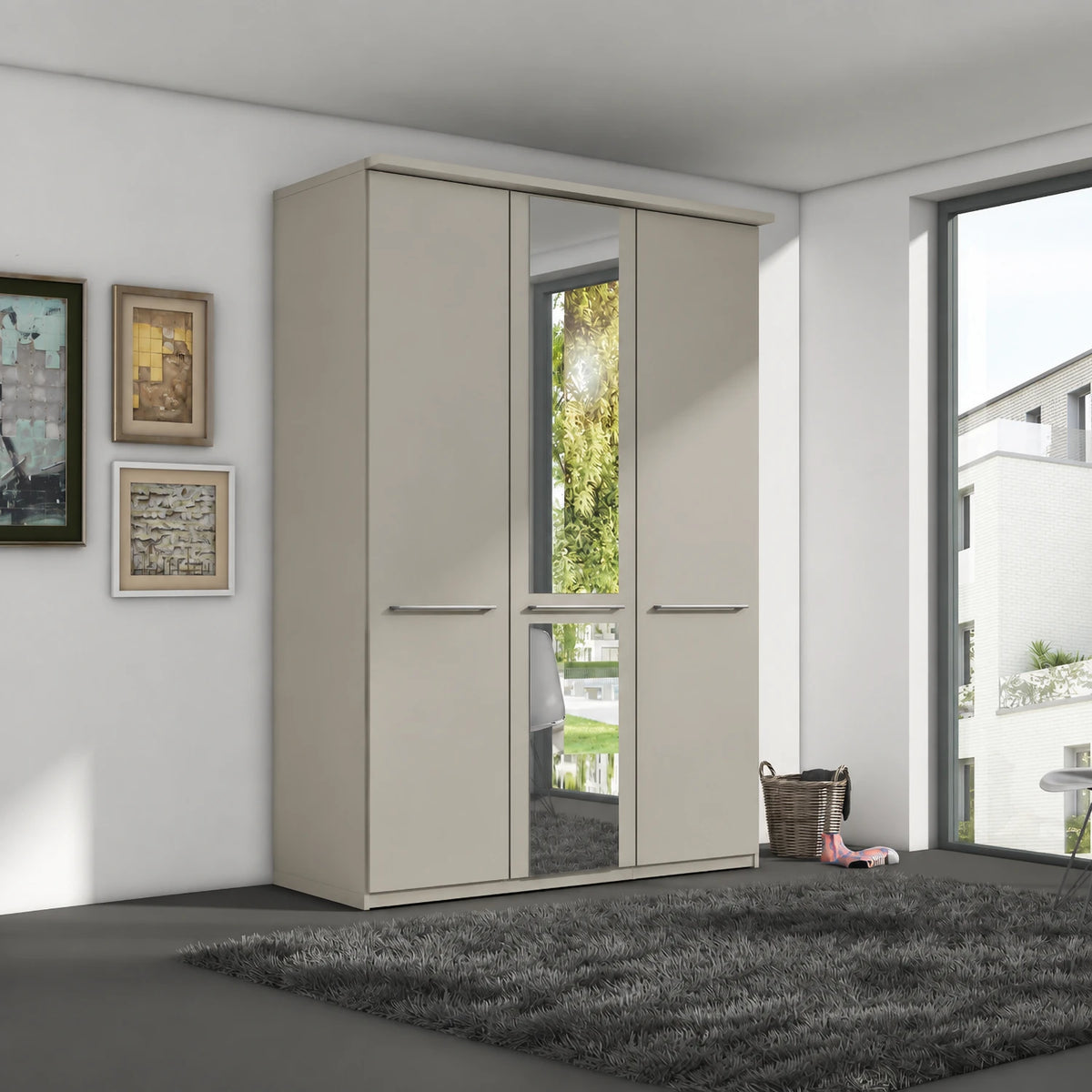 A modern 3-door Wiemann Cairns wardrobe with a mirrored door and two solid doors in a Pebble Grey finish, set in a contemporary room with a dark gray shag rug and framed wall art.