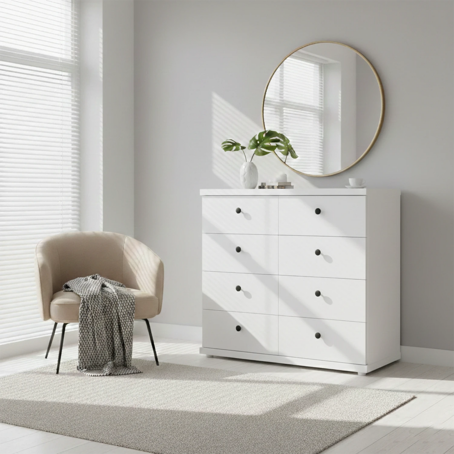 White dresser with round mirror in a bright room