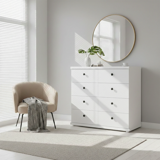 White dresser with round mirror in a bright room