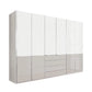 A modern stand alone wardrobe or storage cabinet with a glossy white glass finish, featuring tall doors on the upper section and three drawers on the lower right, shown against a plain white background.