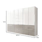 A modern six-door wardrobe with a glossy white glass upper half and a glossy glass Pebble grey lower half, featuring three drawers in the centre. The image includes dimension lines indicating a height of 216 cm, a width of 295.