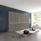 A large modern Wiemann Santa 350cm Combi 7 Doors Wardrobe With Drawers in Havana. The cabinet features glossy Havana Glass doors and drawers with slim silver handles, set against a dark blue accent wall.
