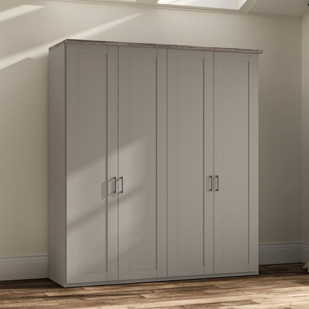 A tall four-door Wiemann trurp wardrobe or closet in a pebble gray finish with a natural wood top, shown in a room with beige walls and wood flooring.