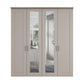 A tall four-door Wiemann Truro wardrobe with paneled doors in Pebble Grey finish, a medium brown top, and slim dark metal handles, shown on a plain white background.