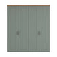 A four-door Truro wardrobe or cabinet with paneled doors in a muted sage green finish, featuring a natural light wood top and slim dark metal handles, shown against a plain white background.