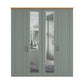 A four-door Wiemann Truro Shaker style wardrobe with paneled doors in a muted sage green, featuring two mirrored glass doors and a natural wood top.
