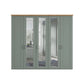 A five-door wiemann Truro wardrobe with a muted sage green painted finish, featuring three mirrored glass doors and three paneled doors, topped with a light natural wood apron.