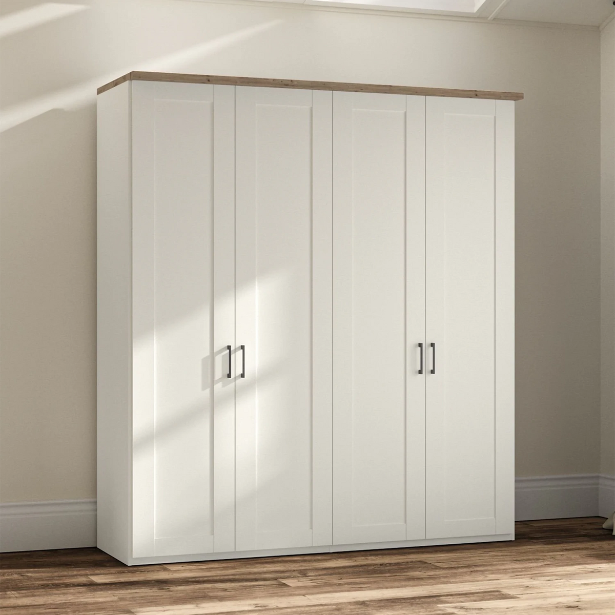A tall white four-door Wiemann Truro wardrobe or closet with a natural wood top and slim black metal handles, shown in a real room with beige walls, wood flooring, and soft window shadows.