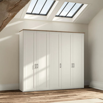 A five-door Wiemann Truro Shaker style wardrobe with paneled doors in a White, featuring a natural wood top cornice.