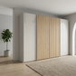 A modern Wiemannn Tulsa  four Door sliding large wardrobe Side two doors in glossy champagne Glass Middle Two Doors with Oak Slats in a Room