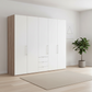 Wiemann Loft 5 Doors & 3 Drawers With Bi-Fold Doors Wardrobe in White with Rustic Oak Carcase styled in a Bedroom
