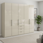 Wiemann Loft 5 Doors & 4 Drawers With Bi-Fold Doors Wardrobe in Glass Champagne styled in a modern room