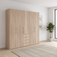 Wiemann Loft 5 Doors & 4 Drawers With Bi-Fold Doors Wardrobe in Rustic Oak styled in a modern room