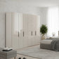 Amelia 300cm 6 Door Bifold Wardrobe with Glass Doors in Champagne - Styled in a Bedroom